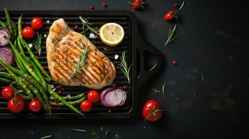 Grilled Chicken Breast with Cherry Tomatoes Green French beans, garlic, herbs, and lemon slices on a Teflon pan. photo