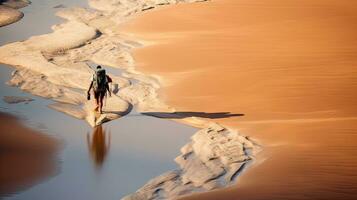 Tourists walking on desert sand dunes with red river aerial view at sunset,Generated with AI photo