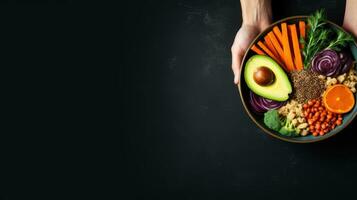 Red quinoa bowl with avocado, radishes, scallions, cherry tomatoes, chives and fresh basil. Top view. Copy space. photo