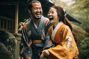 Portrait of a young couple in yukata standing together under the cherry blossom tree. photo