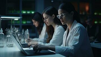 Two female scientists are using laptops in the laboratory. photo