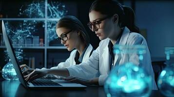 Two female scientists are using laptops in the laboratory. photo