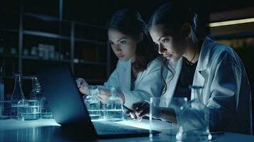 Two female scientists are using laptops in the laboratory. photo