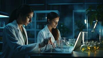 Two female scientists are using laptops in the laboratory. photo