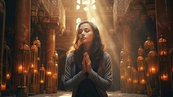 young muslim woman praying ,Young muslim woman praying in mosque photo