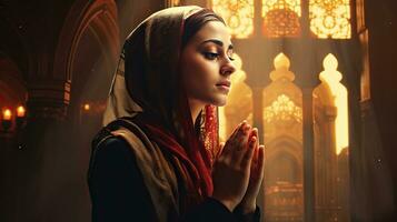 young muslim woman praying ,Young muslim woman praying in mosque photo