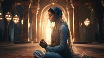 young muslim woman praying ,Young muslim woman praying in mosque photo