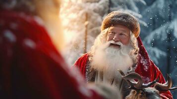 Santa Claus is near his reindeer in the snowy forest photo