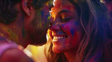 Happy couple puts paint on their faces during Holi celebration. indian holi festival photo