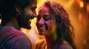Happy couple puts paint on their faces during Holi celebration. indian holi festival photo