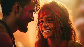 Happy couple puts paint on their faces during Holi celebration. indian holi festival photo