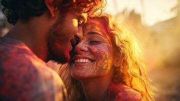 Happy couple puts paint on their faces during Holi celebration. indian holi festival photo