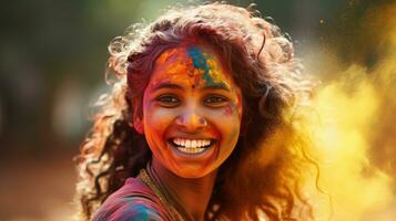 Beautiful happy Indian woman celebrates Holi with colored powder or gulal. indian festival holi photo