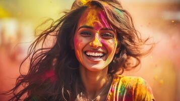 Beautiful happy Indian woman celebrates Holi with colored powder or gulal. indian festival holi photo