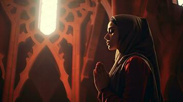 Religious Muslim woman praying in a church photo