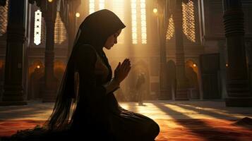 Religious Muslim woman praying in a church photo