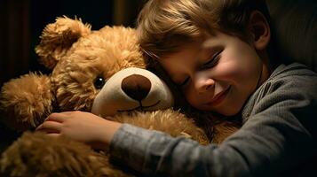 A cute little boy hugs a big soft teddy bear. photo