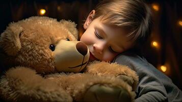 A cute little boy hugs a big soft teddy bear. photo