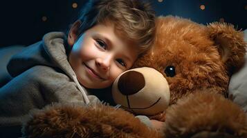 A cute little boy hugs a big soft teddy bear. photo