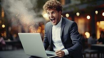 Young businessman in a successful suit shouts with joy Receive notifications from your laptop photo