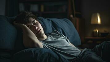 Young man sleeping on sofa at home photo