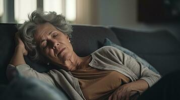 Depressed elderly woman lying on the sofa Depression, ADHD, mental health problems photo