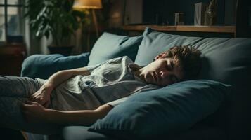 Young man sleeping on sofa at home photo