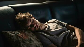 Young man sleeping on sofa at home photo