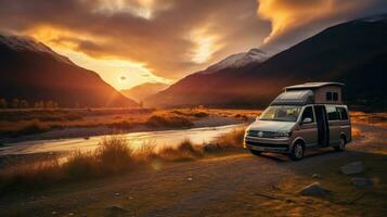 familia cámping coche Vamos en fiesta en un autocaravana, estacionado siguiente a el río, con el montañas detrás el puesta de sol. foto