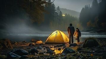 Night camping on the banks of male and female hikers There is thick fog along the river. photo