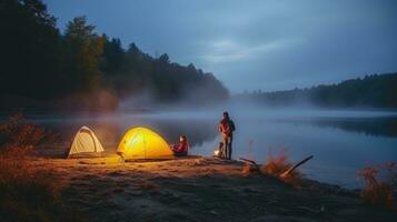 Night camping on the banks of male and female hikers There is thick fog along the river. photo