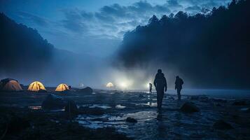 Night camping on the banks of male and female hikers There is thick fog along the river. photo