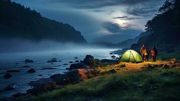 Night camping on the banks of male and female hikers There is thick fog along the river. photo