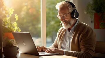 Senior man wearing headphones making a video call on a tablet photo