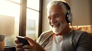 Senior man wearing headphones making a video call on a tablet photo