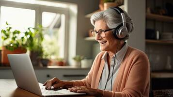 Senior woman wearing headphones making a video call on a tablet photo