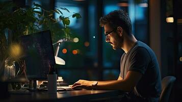 Young male software developer writes a program while working in the office. photo