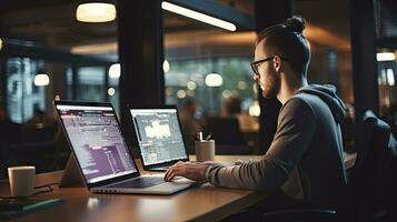 Young male software developer writes a program while working in the office. photo