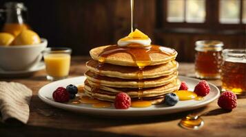 breakfast pancakes on plate with honey and berries photo