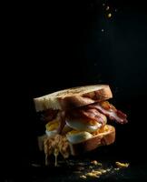 bacon sandwich hanging in the air with eggs and bread photo