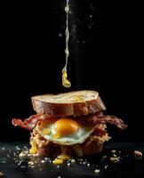 bacon sandwich hanging in the air with eggs and bread photo