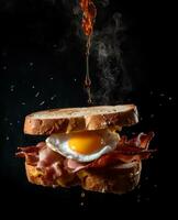 bacon sandwich hanging in the air with eggs and bread photo