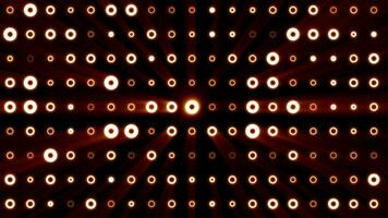 Abstract background of bright orange yellow glowing light bulbs from circles and dots of energy magic disco wall video