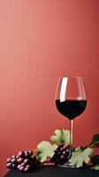 a glass of wine with black grapes on red background generative AI photo