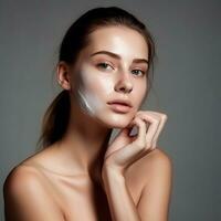 a young girl with skin care product on gray background advertising photo generative AI