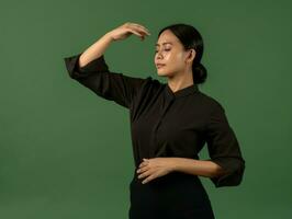 Asian woman in emotional dynamic pose on solid background AI Generative photo