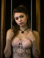 a beautiful young woman in a pink dress posing on a swing generative ai photo