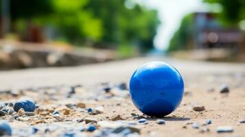 un azul pelota es sentado en el suelo en el medio de un la carretera generativo ai foto