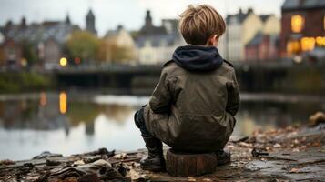 a young boy sitting on a log by a river generative ai photo