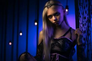 a woman in a gothic outfit posing in front of purple lights generative ai photo